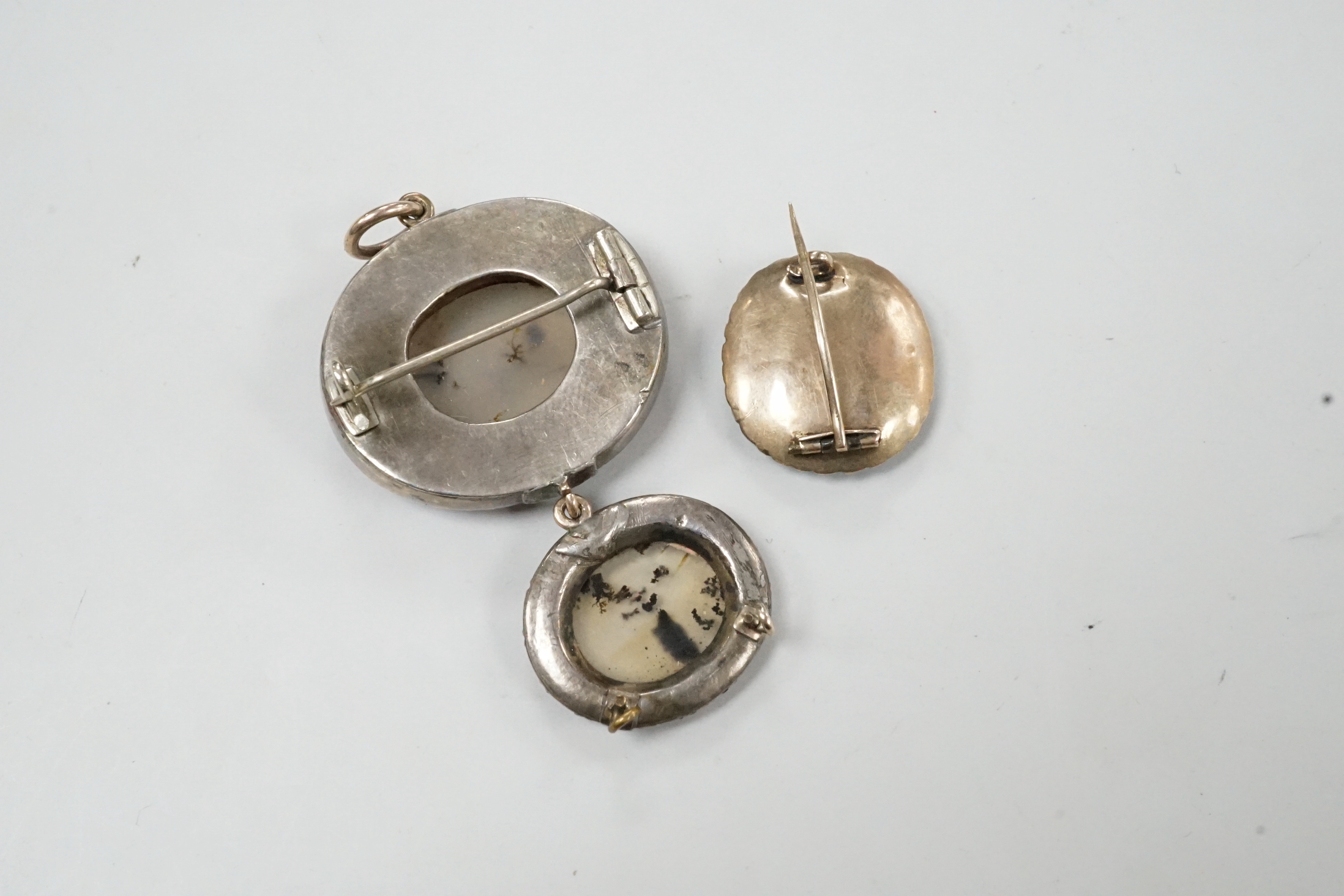 A Georgian white metal, foil backed garnet and moss agate set graduated drop brooch, 46mm and a small garner and turquoise set brooch.